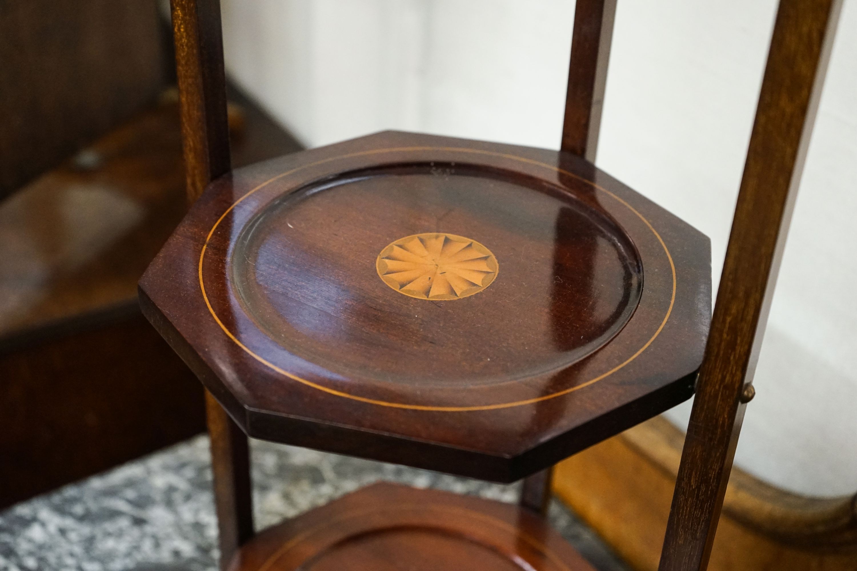 An Edwardian cake stand together with a skeleton framed toilet mirror